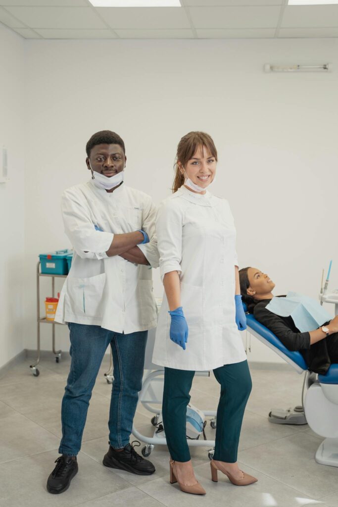 Dentists with patient in a dental clinic providing healthcare services.